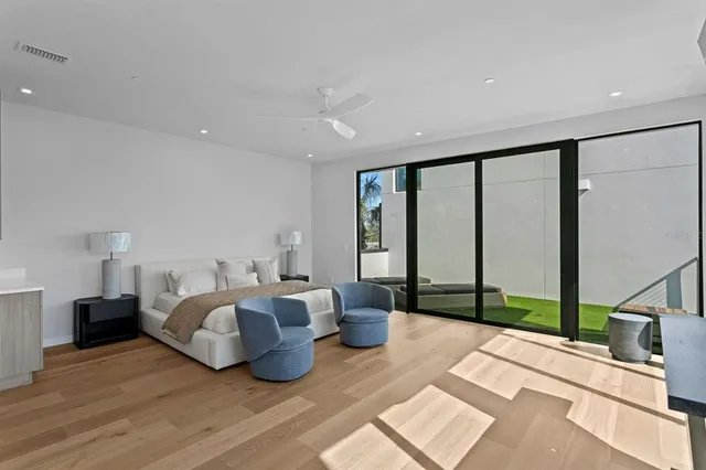 a spacious bedroom with a bed and a large window