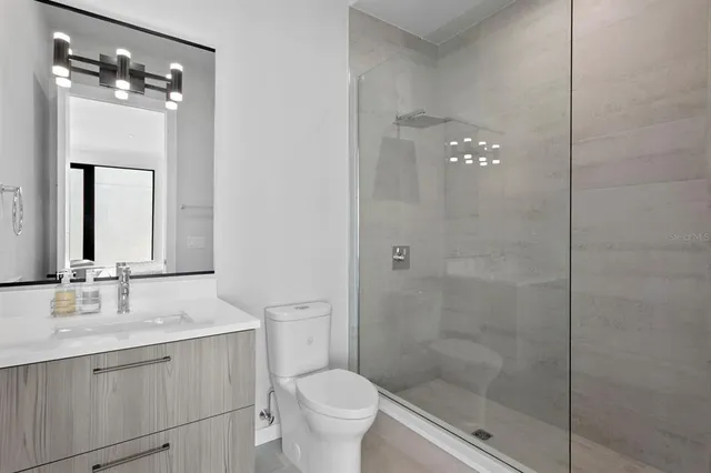 a bedroom with a bed a large window and couch