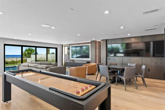 a dining room with furniture and a flat screen tv