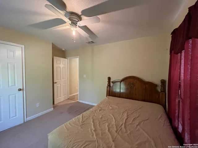 a bathroom with a sink a toilet a mirror and shower