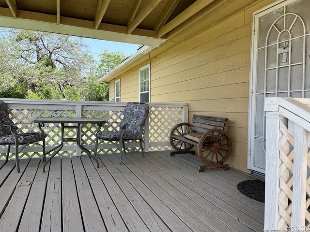 a view of deck with table and chairs and wooden floor