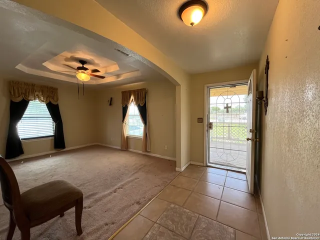 a view of a livingroom with furniture and a ceiling fan