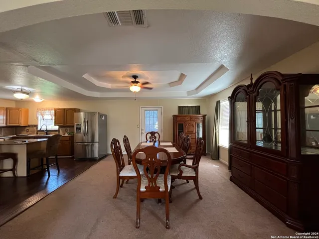 a view of a dining room with furniture and window