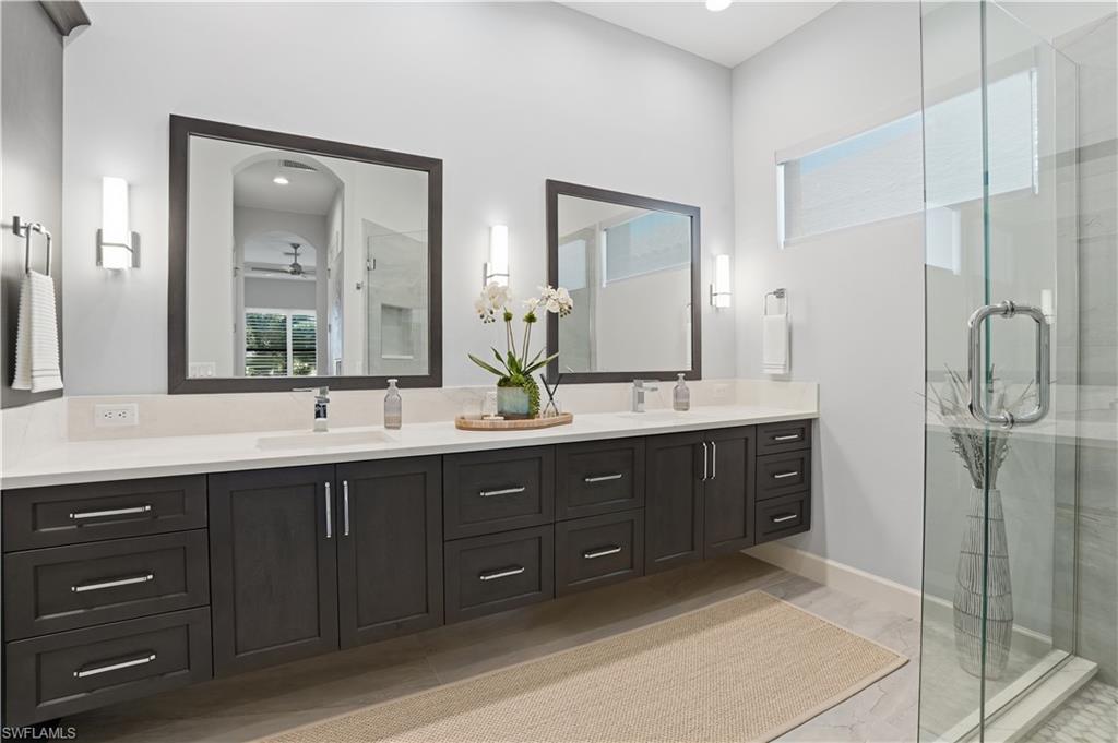 8665 Dilillo Court Naples, FL 34119 - Photo 14 of 42 a bathroom with a double vanity sink mirror and double