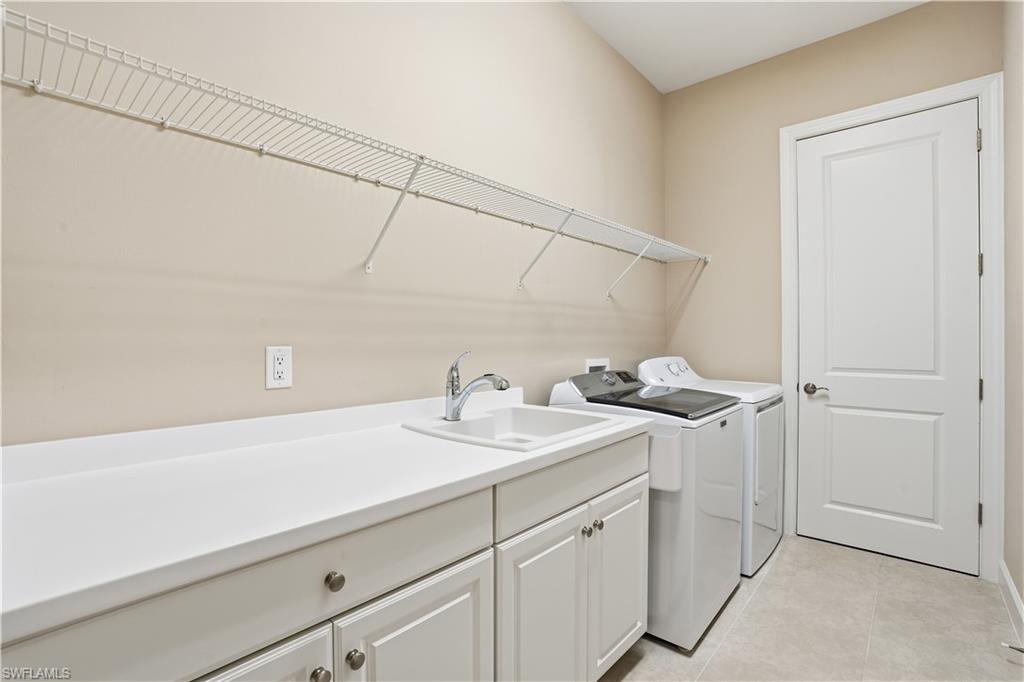 8665 Dilillo Court Naples, FL 34119 - Photo 19 of 42 a bathroom with a sink and a mirror