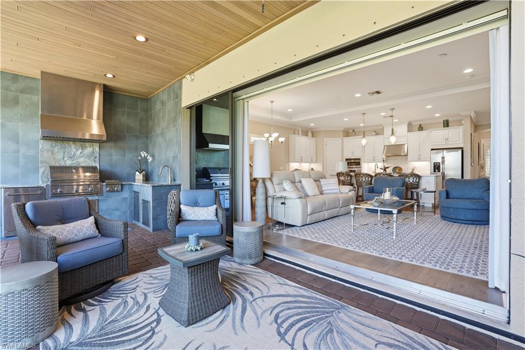 8665 Dilillo Court Naples, FL 34119 - Photo 20 of 42 a living room with furniture and wooden floor