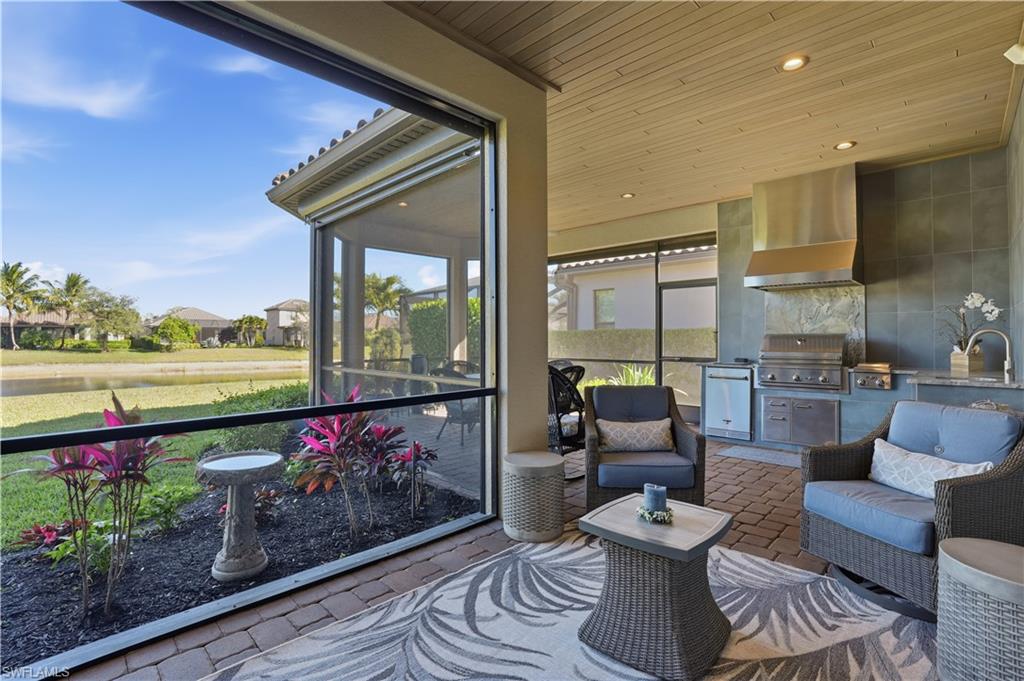 8665 Dilillo Court Naples, FL 34119 - Photo 21 of 42 a outdoor living space with furniture and garden view