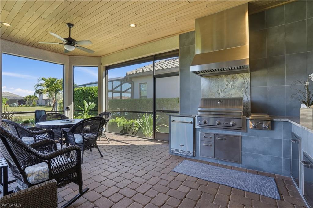 8665 Dilillo Court Naples, FL 34119 - Photo 25 of 42 a dining room with furniture a chandelier and wooden floor