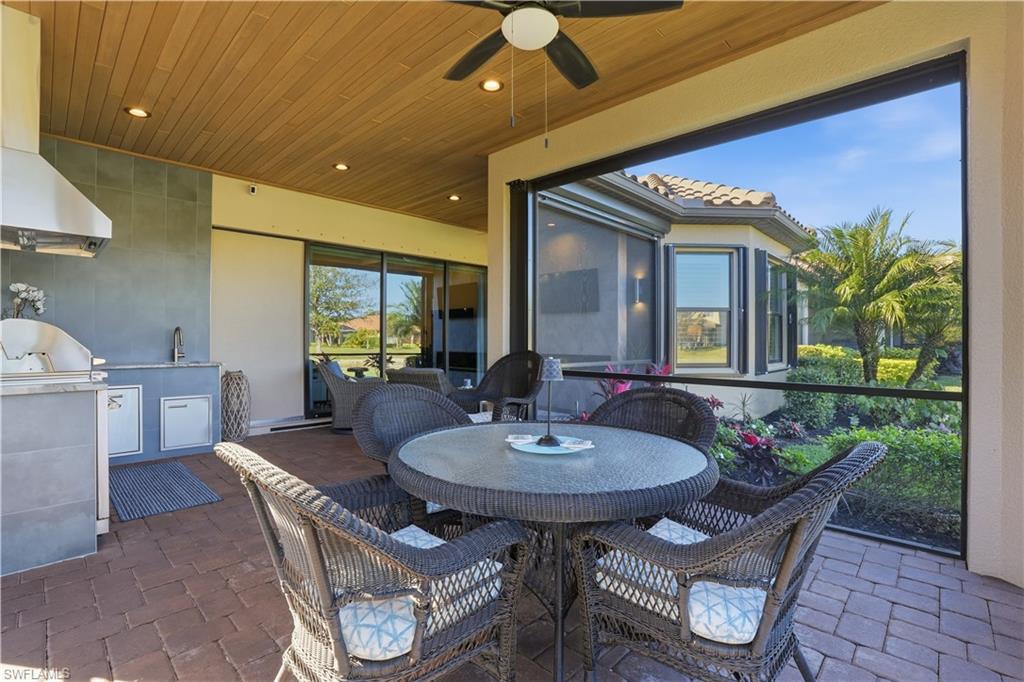 8665 Dilillo Court Naples, FL 34119 - Photo 26 of 42 a view of a dining room with furniture and wooden floor