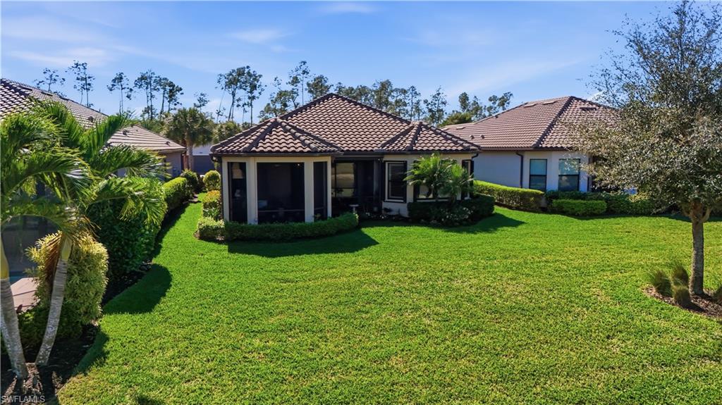 8665 Dilillo Court Naples, FL 34119 - Photo 29 of 42 a front view of a house with garden