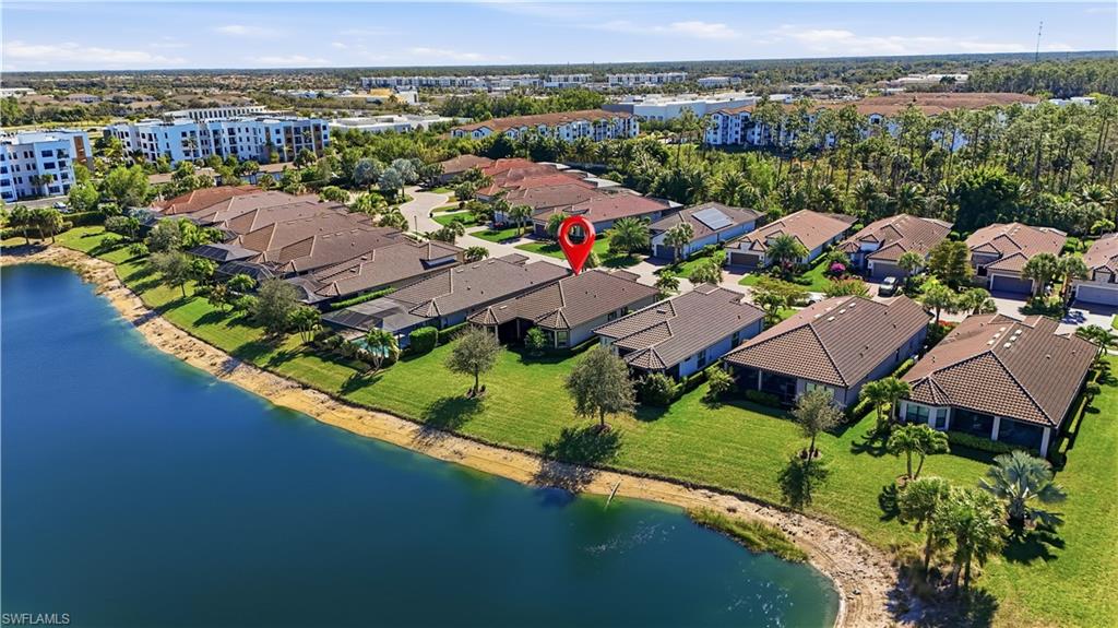 8665 Dilillo Court Naples, FL 34119 - Photo 30 of 42 an aerial view of lake and residential houses with outdoor space