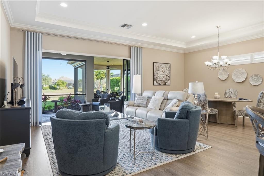 8665 Dilillo Court Naples, FL 34119 - Photo 3 of 42 a living room with furniture potted plant and a large window