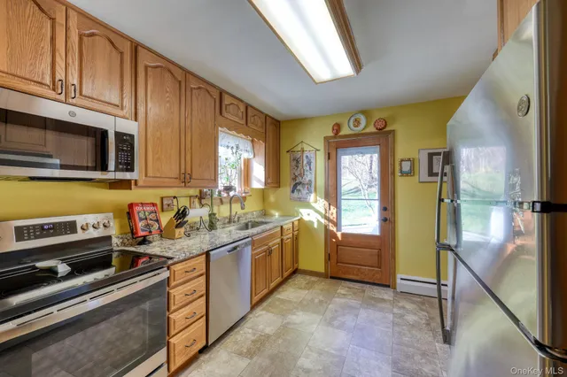 a kitchen with stainless steel appliances granite countertop a stove and a refrigerator