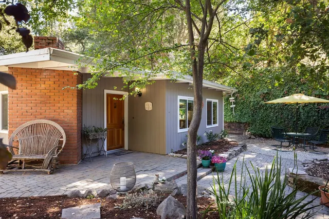a front view of a house with garden