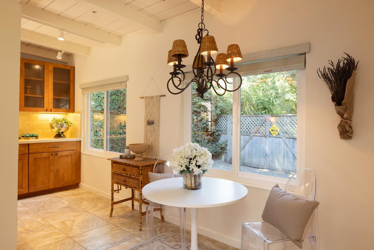 32 Southbank Road Carmel Valley, CA 93924 - Photo 6 of 21 a dining room with wooden floor a chandelier a wooden table and chairs