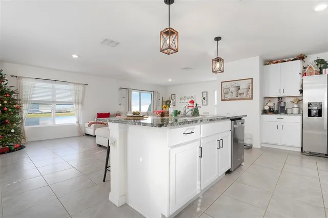 a kitchen with cabinets and window