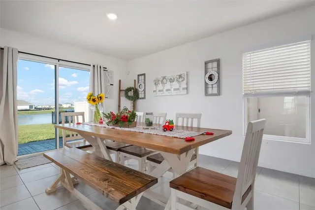 a view of a dining room with furniture a chandelier and wooden floor