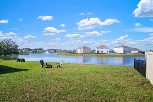 a view of a lake with houses in the back