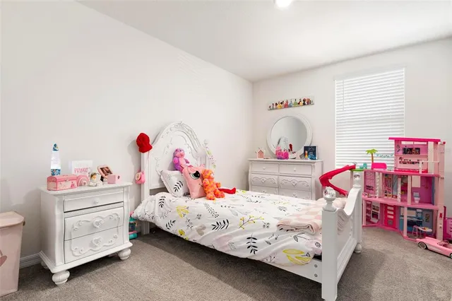 a bedroom with bed and a chandelier