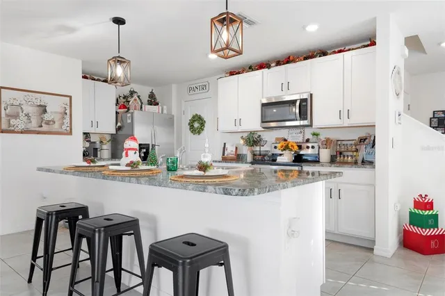 a kitchen with stainless steel appliances granite countertop a sink and cabinets