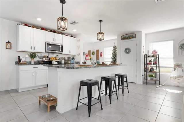 a kitchen with stainless steel appliances granite countertop a sink and a refrigerator