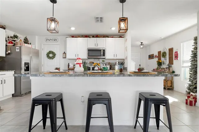 a kitchen with cabinets a sink and appliances