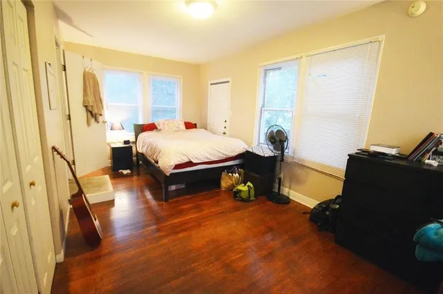 a spacious bedroom with a bed and a window