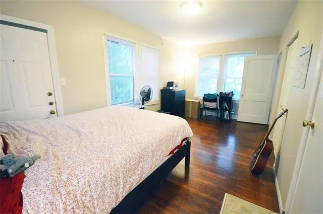 a bed room with a bed and large window