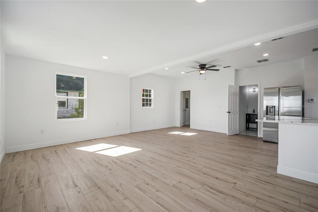 38835 Pine Street Umatilla, FL 32784 - Photo 11 of 36 a view of an empty room with wooden floor and a window