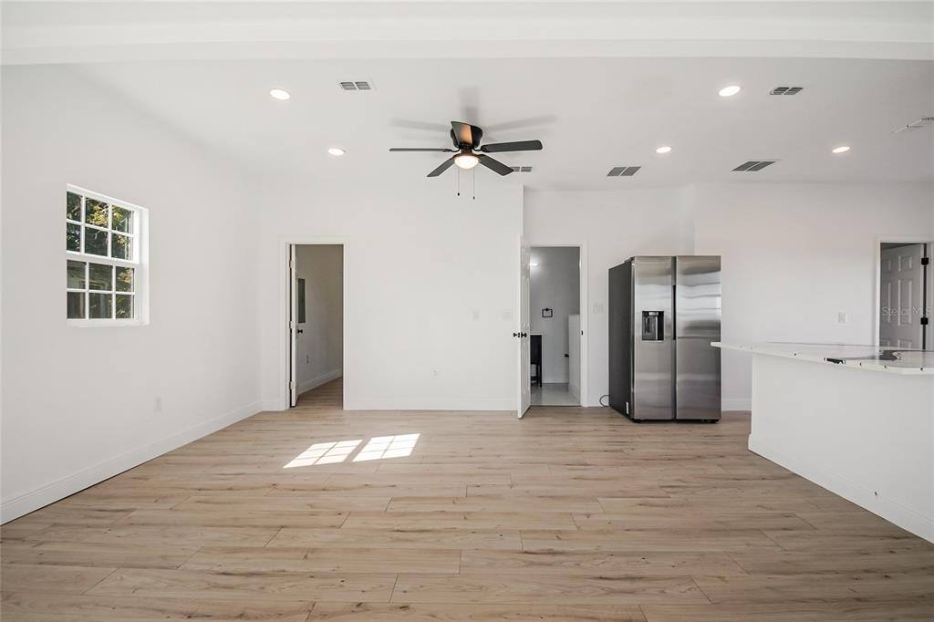 38835 Pine Street Umatilla, FL 32784 - Photo 14 of 36 a view of empty room with wooden floor and ceiling fan