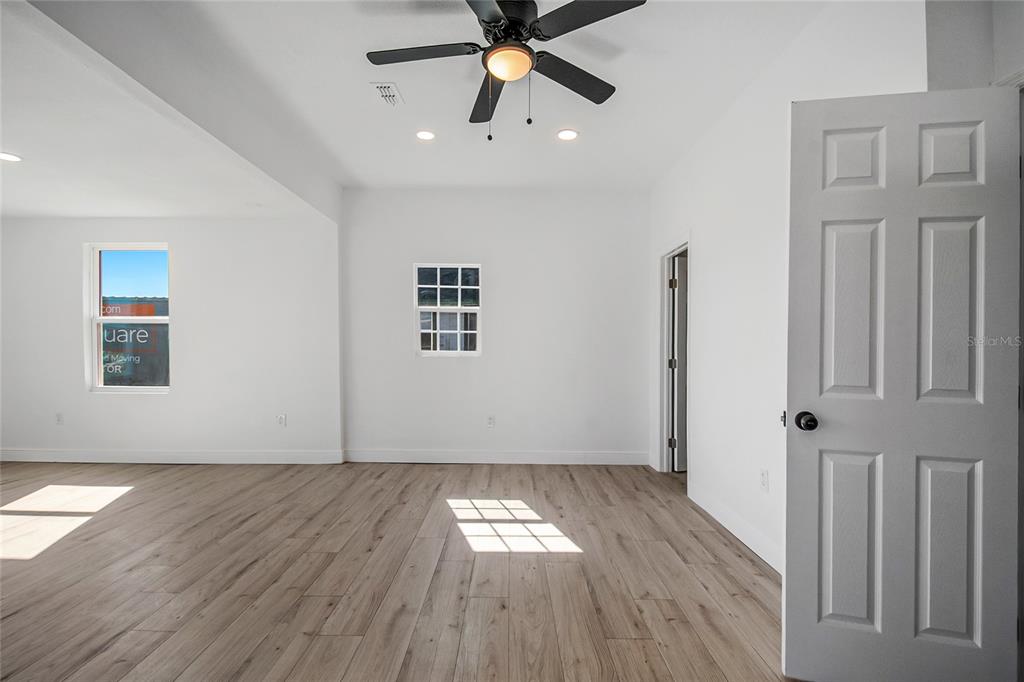 38835 Pine Street Umatilla, FL 32784 - Photo 15 of 36 a view of empty room with wooden floor and fan