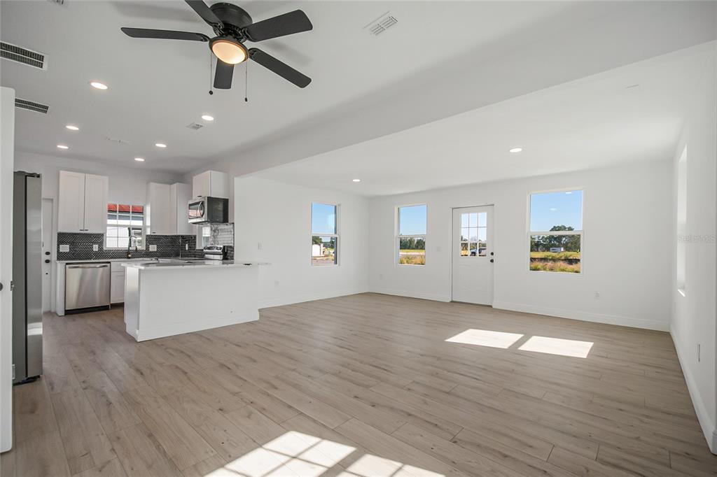 38835 Pine Street Umatilla, FL 32784 - Photo 16 of 36 a view of kitchen with cabinets and wooden floor