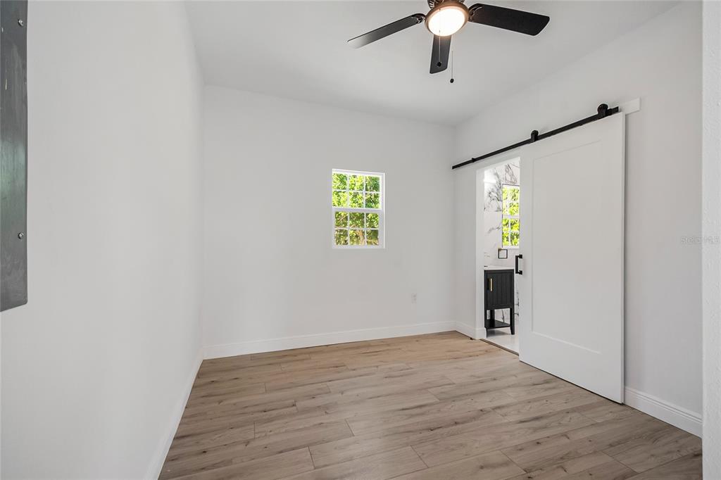 38835 Pine Street Umatilla, FL 32784 - Photo 17 of 36 a view of empty room with window and wooden floor