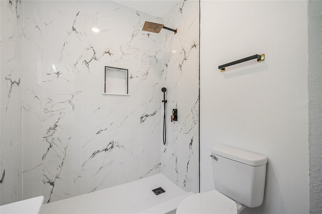 38835 Pine Street Umatilla, FL 32784 - Photo 19 of 36 a bathroom with a shower and toilet