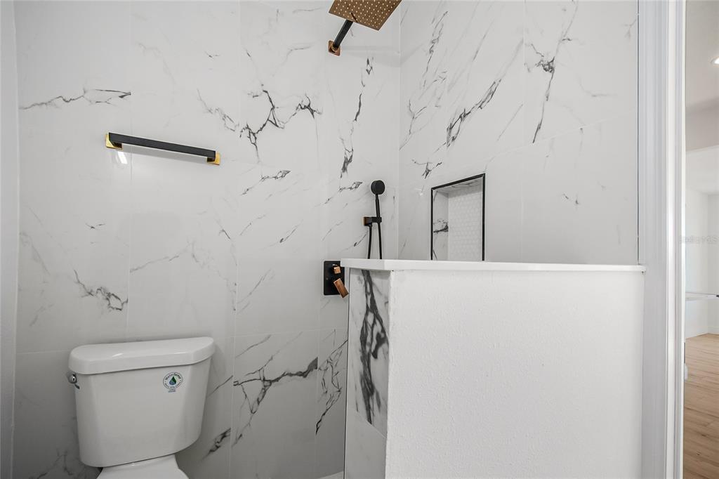 38835 Pine Street Umatilla, FL 32784 - Photo 22 of 36 a bathroom with a toilet and a shower