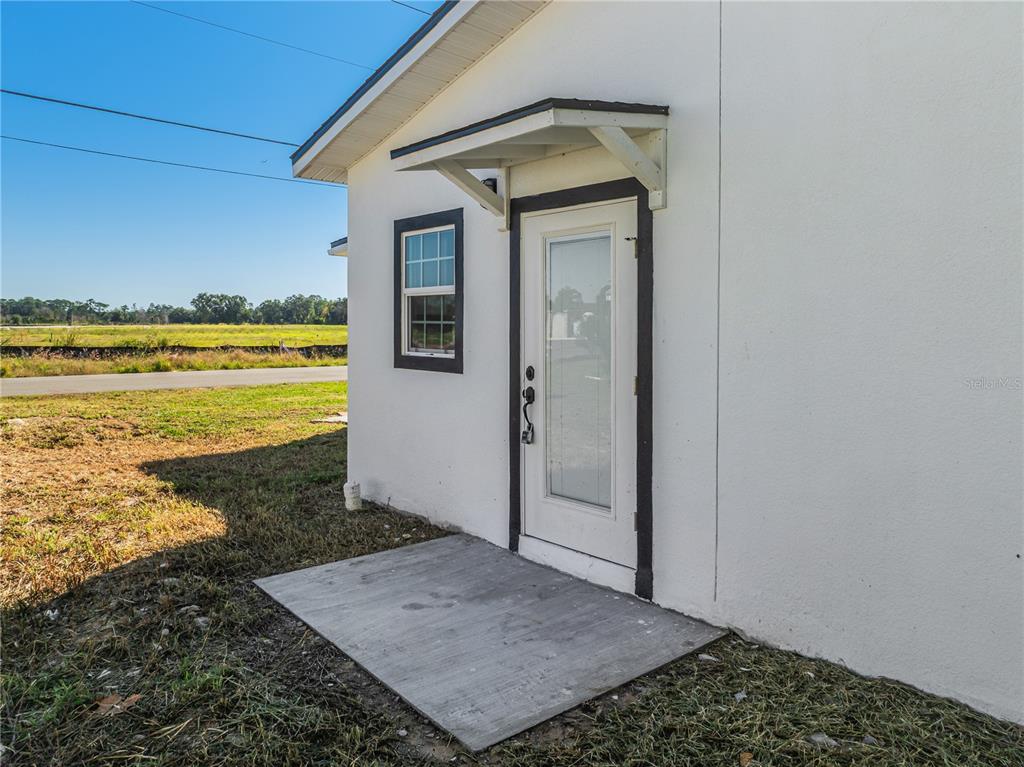 38835 Pine Street Umatilla, FL 32784 - Photo 31 of 36 a view of a hallway to a house