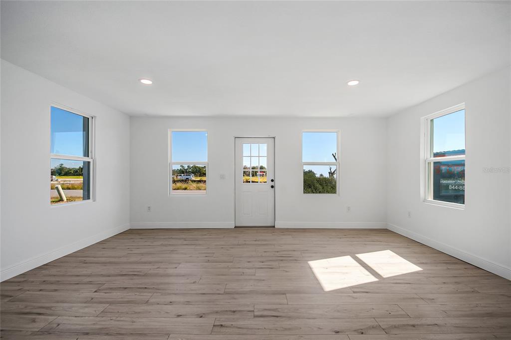 38835 Pine Street Umatilla, FL 32784 - Photo 9 of 36 a view of livingroom with hardwood floor and window