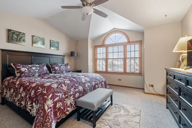 a bed room with a bed window and a television