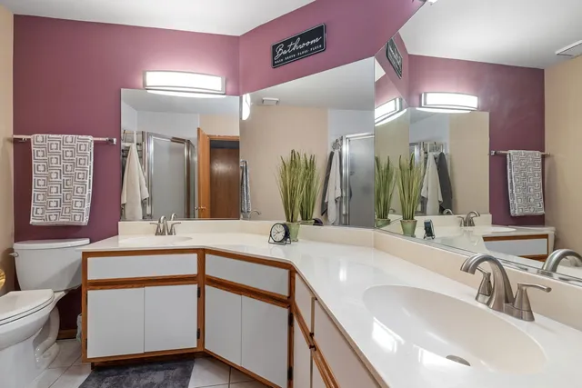 a bathroom with a double vanity sink and a mirror