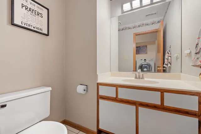 a bathroom with a toilet sink and mirror