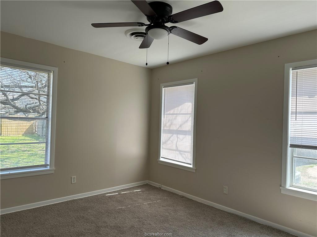 4005 College Main Street Bryan, TX 77801 - Photo 11 of 18 an empty room with a window and a fan