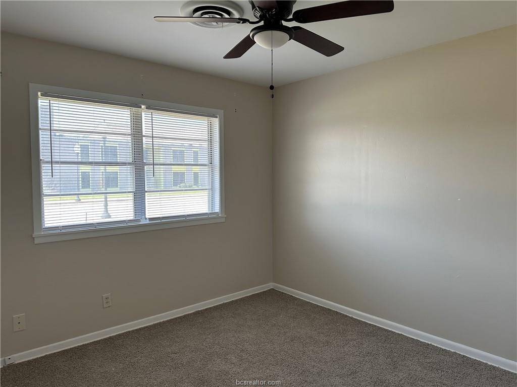 4005 College Main Street Bryan, TX 77801 - Photo 13 of 18 an empty room with a window and a fan