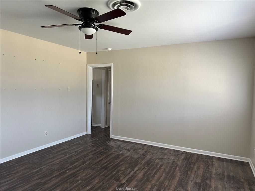 4005 College Main Street Bryan, TX 77801 - Photo 16 of 18 an empty room with wooden floor ceiling fan and window