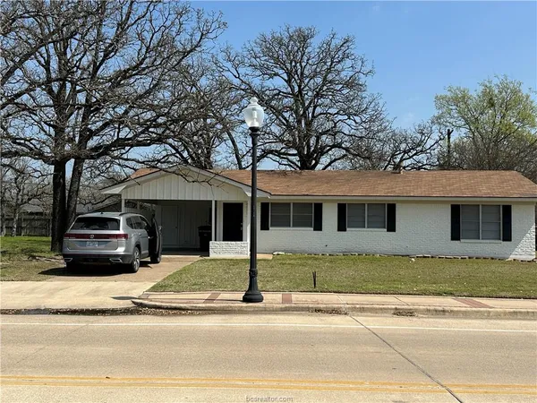 a house that has a tree in front of it