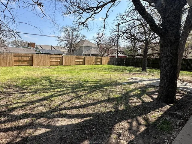 a big yard with large trees