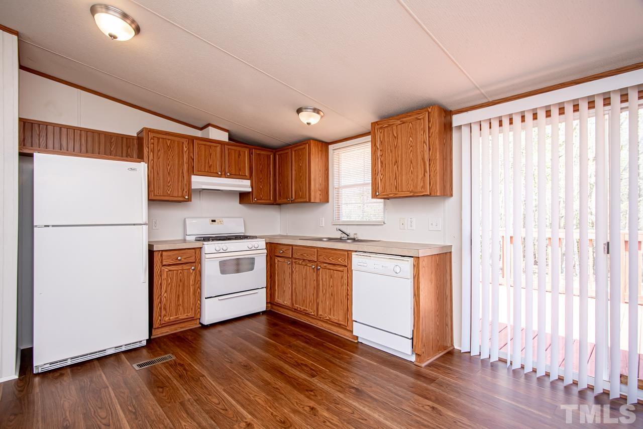 1545 Cheves Road Zebulon, NC 27597 - Photo 15 of 28 a kitchen with stainless steel appliances granite countertop a refrigerator sink and cabinets