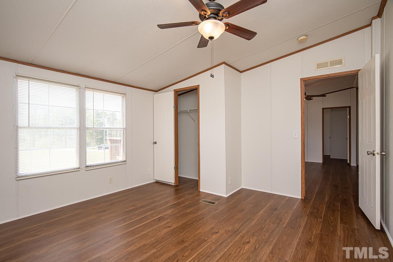 1545 Cheves Road Zebulon, NC 27597 - Photo 18 of 28 a view of an empty room with wooden floor and a window