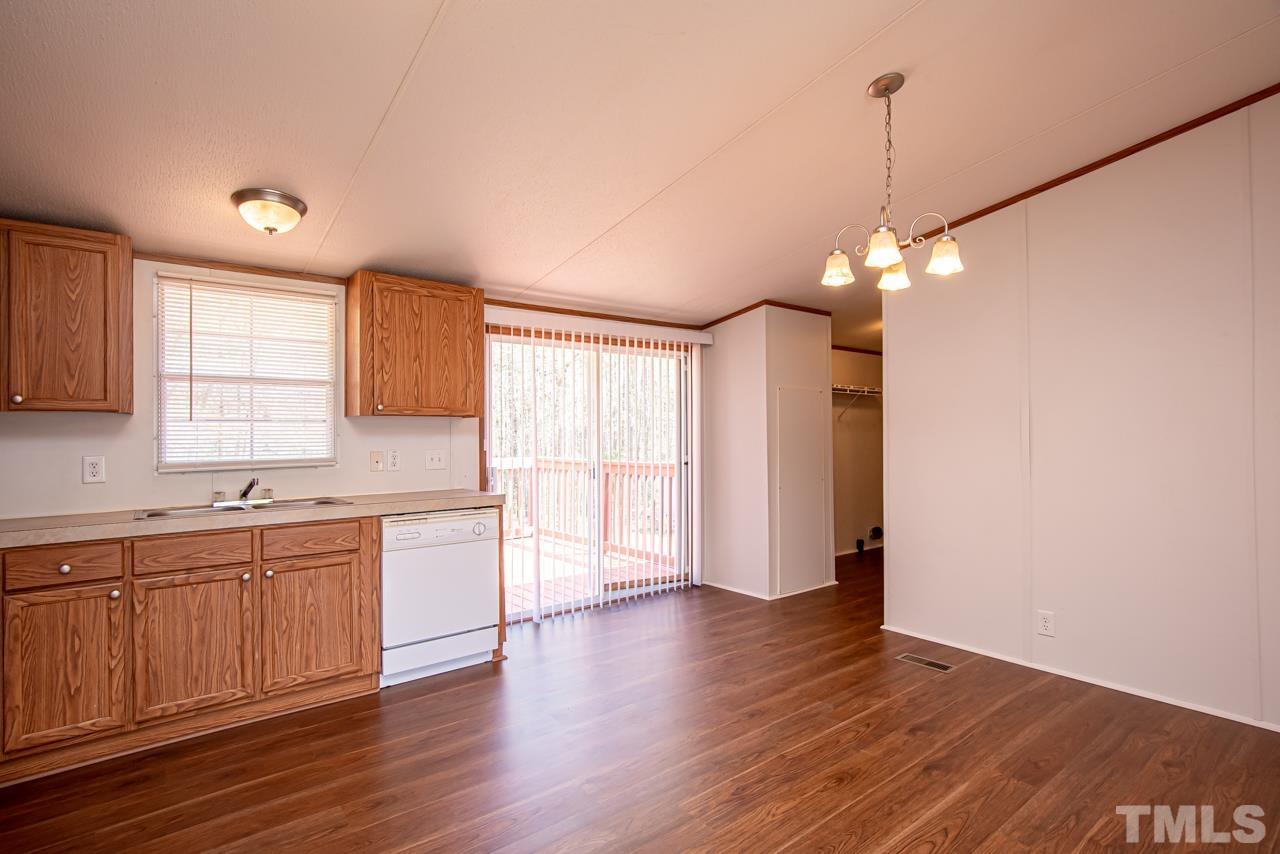 1545 Cheves Road Zebulon, NC 27597 - Photo 20 of 28 a view of a kitchen with a sink and dishwasher wooden cabinets