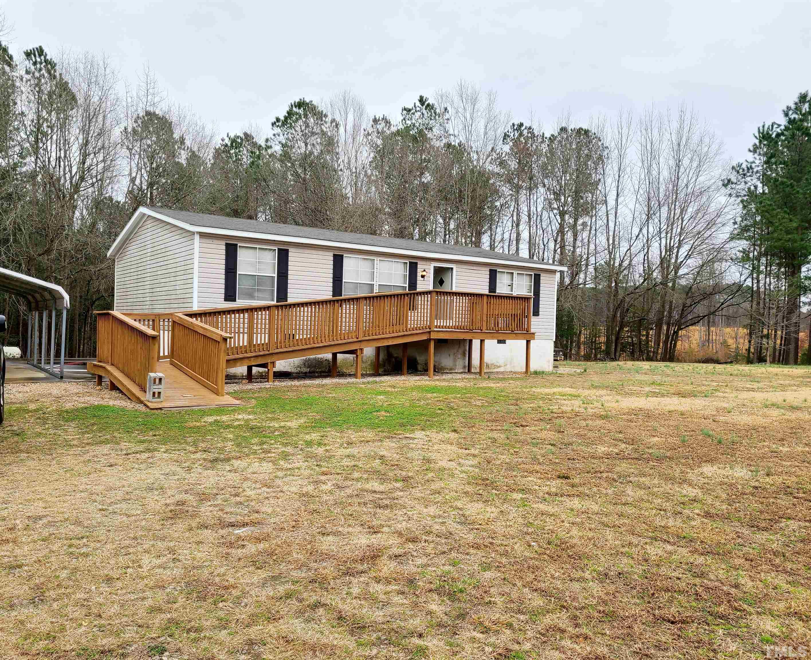 1545 Cheves Road Zebulon, NC 27597 - Photo 2 of 28 a front view of a house with a yard