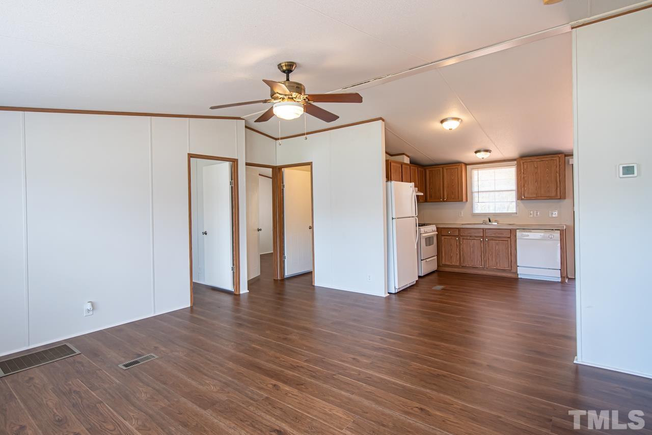 1545 Cheves Road Zebulon, NC 27597 - Photo 21 of 28 a view of a kitchen with a sink and a refrigerator